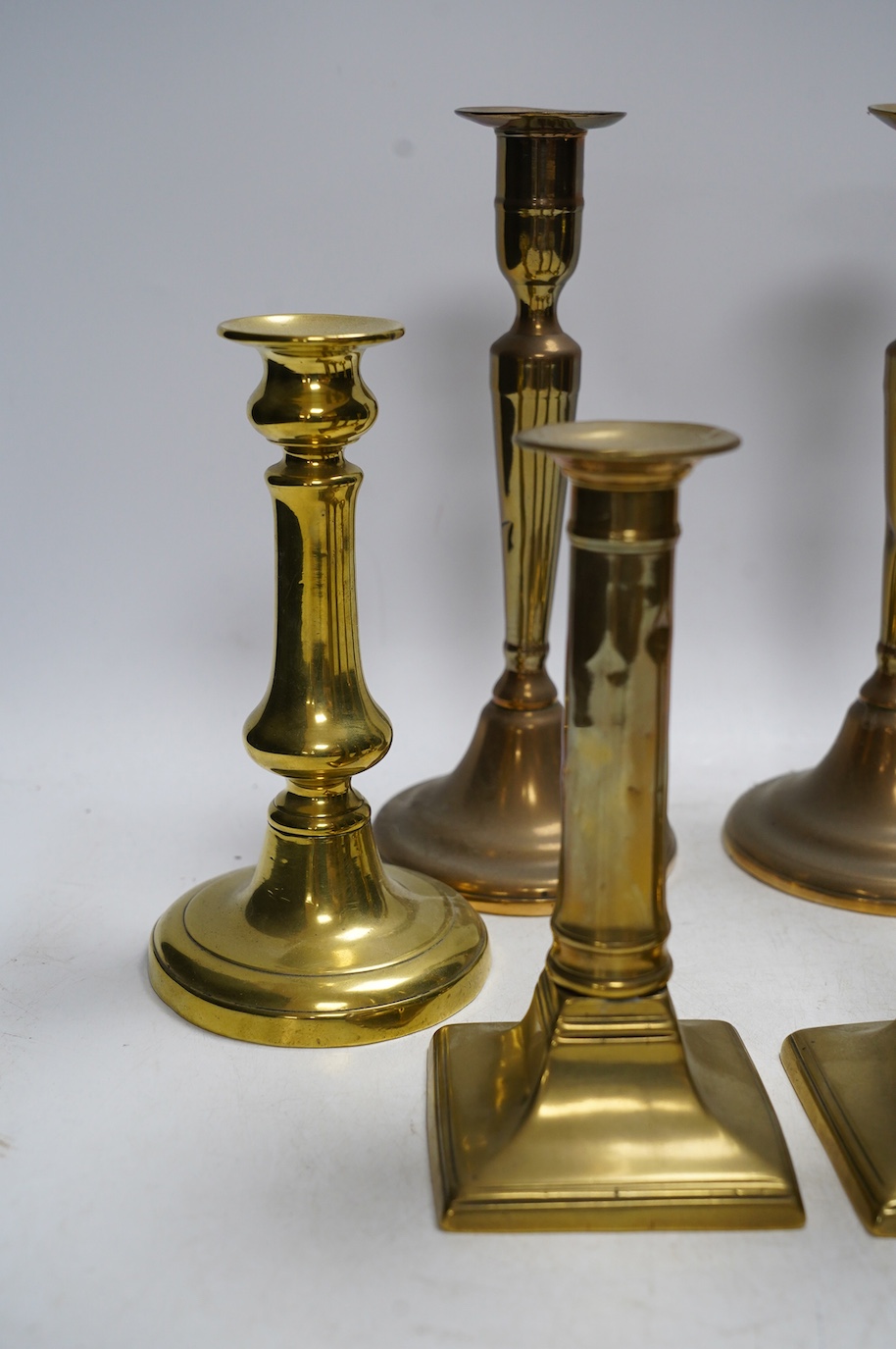 Three pairs of brass candlesticks, tallest 24cm. Condition - fair to good